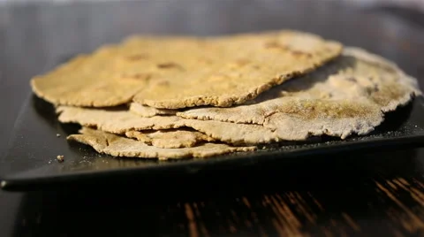 Flatbreads on the black plate Stock Footage 67479420