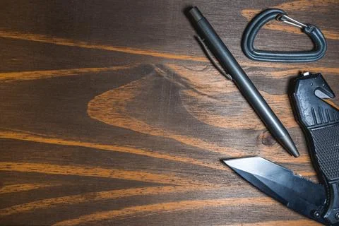Flatlay background of some EDC gear, Knife, Carabiner and a pen Stock Photos