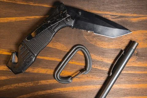 Flatlay background of some EDC gear, Knife, Carabiner and a pen Stock Photos