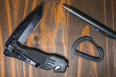 Flatlay background of some EDC gear, Knife, Carabiner and a pen Stock Photos