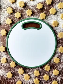 Flatlay baking background with raw coocies srars, flour and white round board Stock Photos