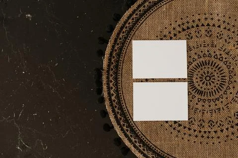 Flatlay of blank paper cards on wicker rug. Business template. Top view, flat Stock Photos