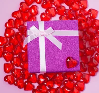 Flatlay with bright pink gift box with white atlas ribbon on pink background  Stock Photos