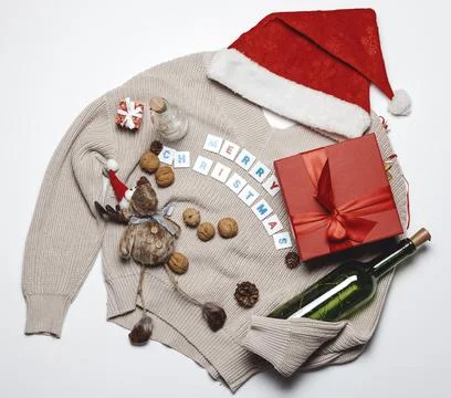 Flatlay composition with a Santa hat, a warm sweater and festive things Stock Photos