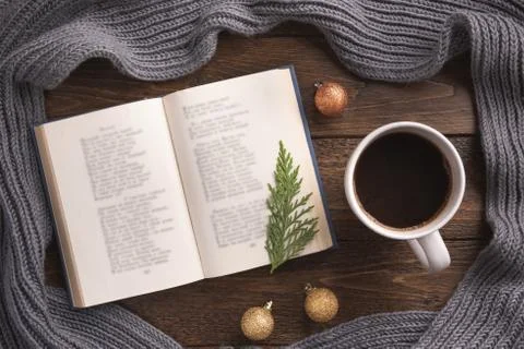 Flatlay composition with white knitted scarf, cup of coffe and open book on w Stock Photos