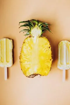 Flatlay with cup pineapple and two fruit popsicles Stock Photos