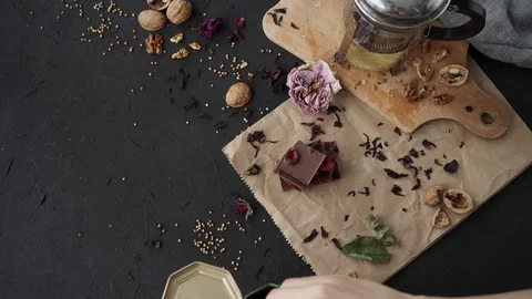 Flatlay on dark background with chocolate, walnut, wood board and paper Video stock 90524943