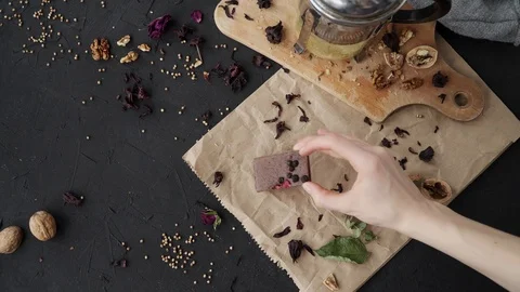 Flatlay on dark background with chocolate, walnut, wood board and paper Stock Footage 90525032