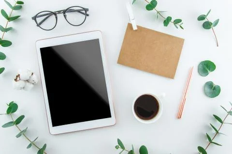 Flatlay digital tablet blank screen on work desk with glasses and coffee Stock Photos