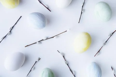 Flatlay with Easter colored eggs and willow catkins on a white background Stock Photos