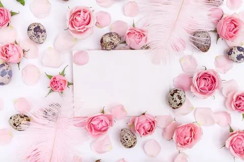 Flatlay Easter composition with quail eggs, feathers and roses Stock Photos