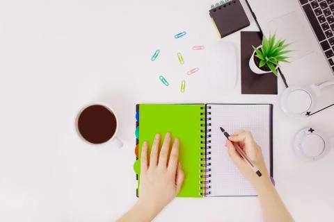 Flatlay with female hands writing a note. Stock Photos