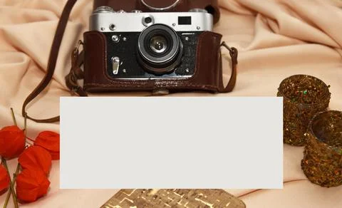 Flatlay. Film camera in case, notebook, fisalis and candlesticks lie on a bei Stock Photos