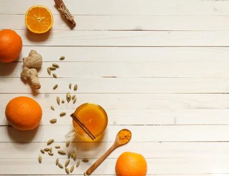 Flatlay with ginger tea and oranges on light boards with space Stock Photos