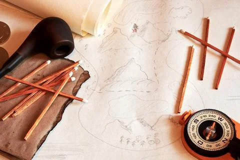 Flatlay image of treasures map with smoking pipe, matches, compass Stock Photos