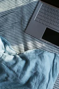 Flatlay of a laptop on a bed Stock Photos