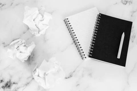 Flatlay of mini spiral notebooks on marble desk Stock Photos
