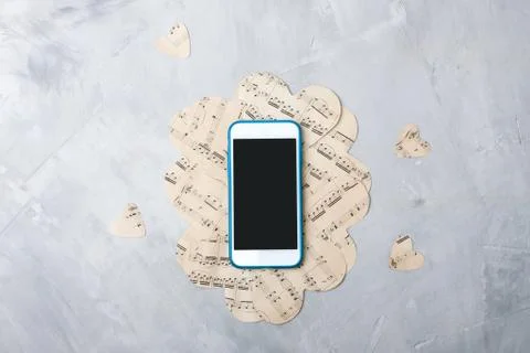 Flatlay music composition smartphone or mobile phone, paper hearts Stock Photos