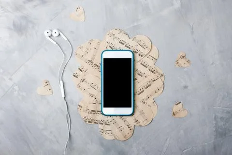 Flatlay music composition smartphone or mobile phone, paper hearts, headphone Stock Photos