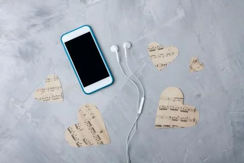 Flatlay music composition smartphone or mobile phone, paper hearts, headphone Stock Photos