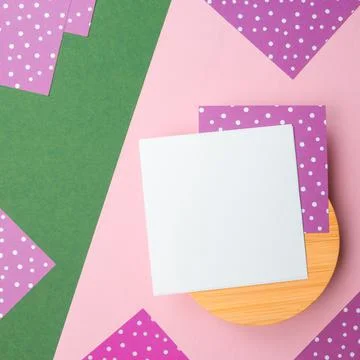 Flatlay note sheet,round wooden base,pink green paper,lilac polka dot,copy space Stock Photos
