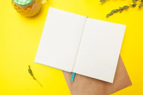 Flatlay of open notepad with envelope and dry leaves and juice Stock Photos