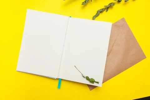 Flatlay of open notepad with envelope and dry leaves Stock Photos