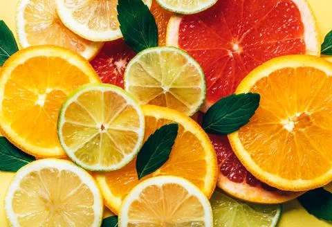 Flatlay pattern of citrus orange, lemon, lime and grapefruit slices background Stock Photos