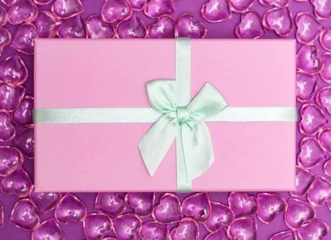 Flatlay with pink gift box with minty atlas ribbon on background from pink de Stock Photos