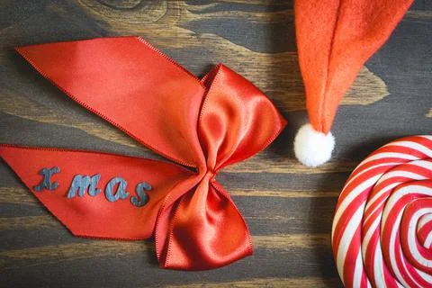 Flatlay of some Red typical Christmas decorations, on a dark wooden background. Stock Photos