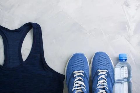 Flatlay sport composition with outfit blue sneakers and t-shirt Stock Photos