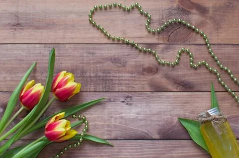 Flatlay Spring Easter bouquet of tulip flowers with cosmetic product on wood Stock Photos