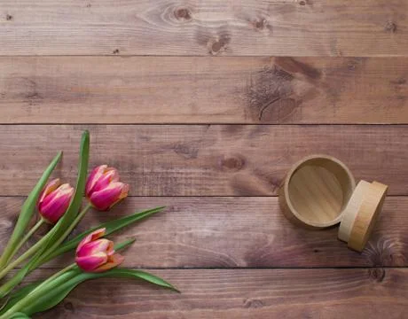 Flatlay Spring Easter bouquet of tulip flowers with wood empty box on wooden Stock Photos