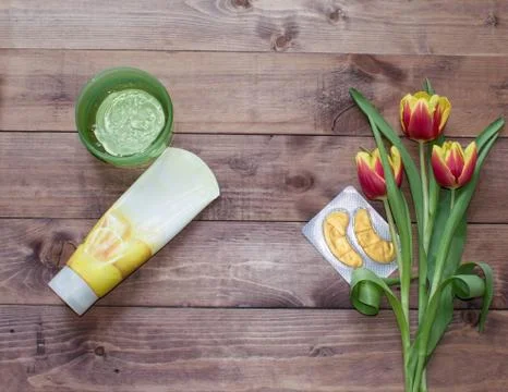 Flatlay Spring Easter bouquet of tulip flower with cosmetic products, patches Stock Photos