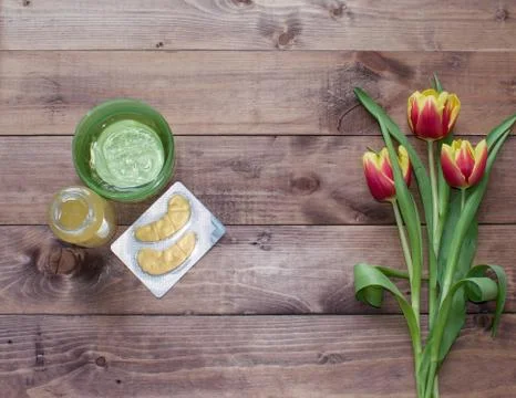 Flatlay Spring Easter bouquet of tulip flower with cosmetic products, patches Stock Photos