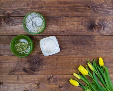 Flatlay Spring Easter bouquet of yellow tulips with cosmetic products on brow Stock Photos