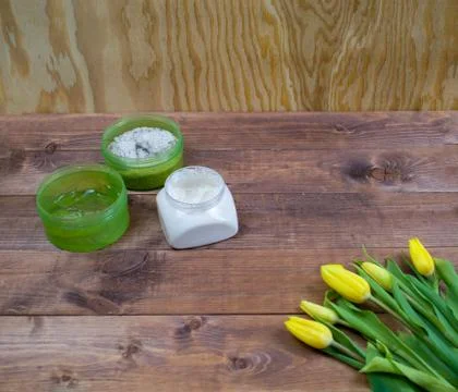 Flatlay Spring Easter bouquet of yellow tulips with cosmetic products on brow Stock Photos