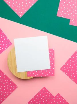 Flatlay square note sheet on wooden base,green diagonal paper,pink paper corners Stock Photos