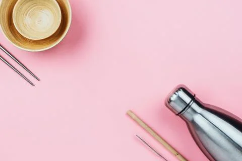 Flatlay of sustainable zero waste kitchenware: metal bottle, wooden bamboo bo Stock Photos
