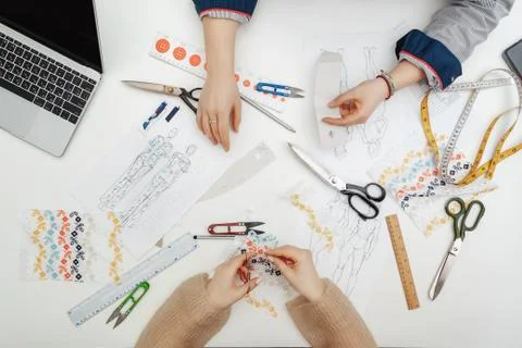 Flatlay at the table with hands and sewing instruments Stock Photos