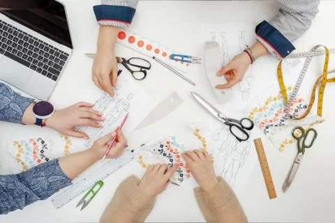 Flatlay at the table with hands and sewing instruments Stock Photos