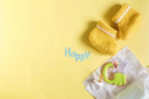 Flatlay things for a small child and the word "happy" in blue letters Stock Photos