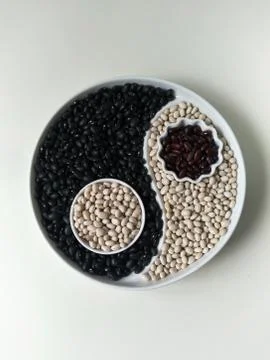 Flatlay, top view, three colors of beans on a Yin Yang plate, white haricot, Stock Photos