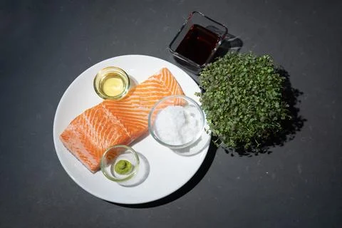 Flatlay Toptable raw Salmon or trout steak fillet on white dish with salt, .. Stock Photos