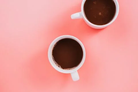 Flatlay of two cup vegan cocoa or hot chocolate on pink Stock Photos