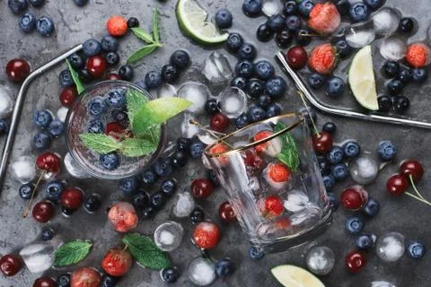 Flatlay of two cups with iced soda water on dark background with eco metal st Stock Photos