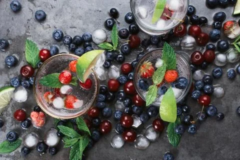 Flatlay of two cups with iced soda water on dark background with eco metal st Stock Photos