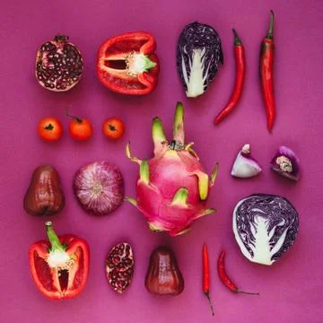 Flatlay of various red, violet and pink fruits and vegetables knolled togethe Stock Photos