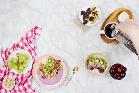 Flatlay of vegan breakfast with plant based yogurt bowls topped with kiwi sli Stock Photos