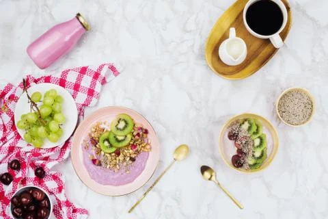 Flatlay of vegan breakfast with plant based yogurt bowls topped with kiwi sli Stock Photos